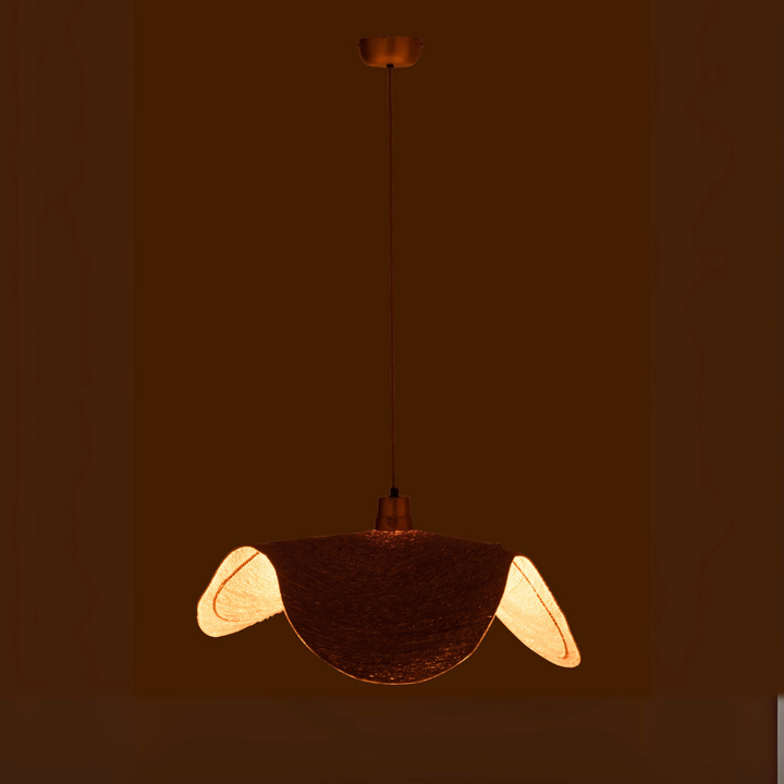 Natural fiber Boucan ceiling lamp glowing with light in a cozy dark setting.