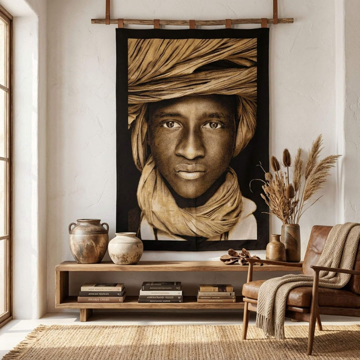 Interior styling scene with the Tuareg Child Tapestry displayed above a console table in a warm, natural space.