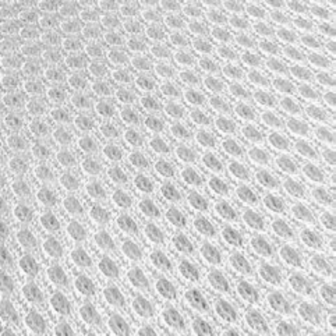 Close-up detail of the micro-perforated breathable fabric surface of the bed base.
