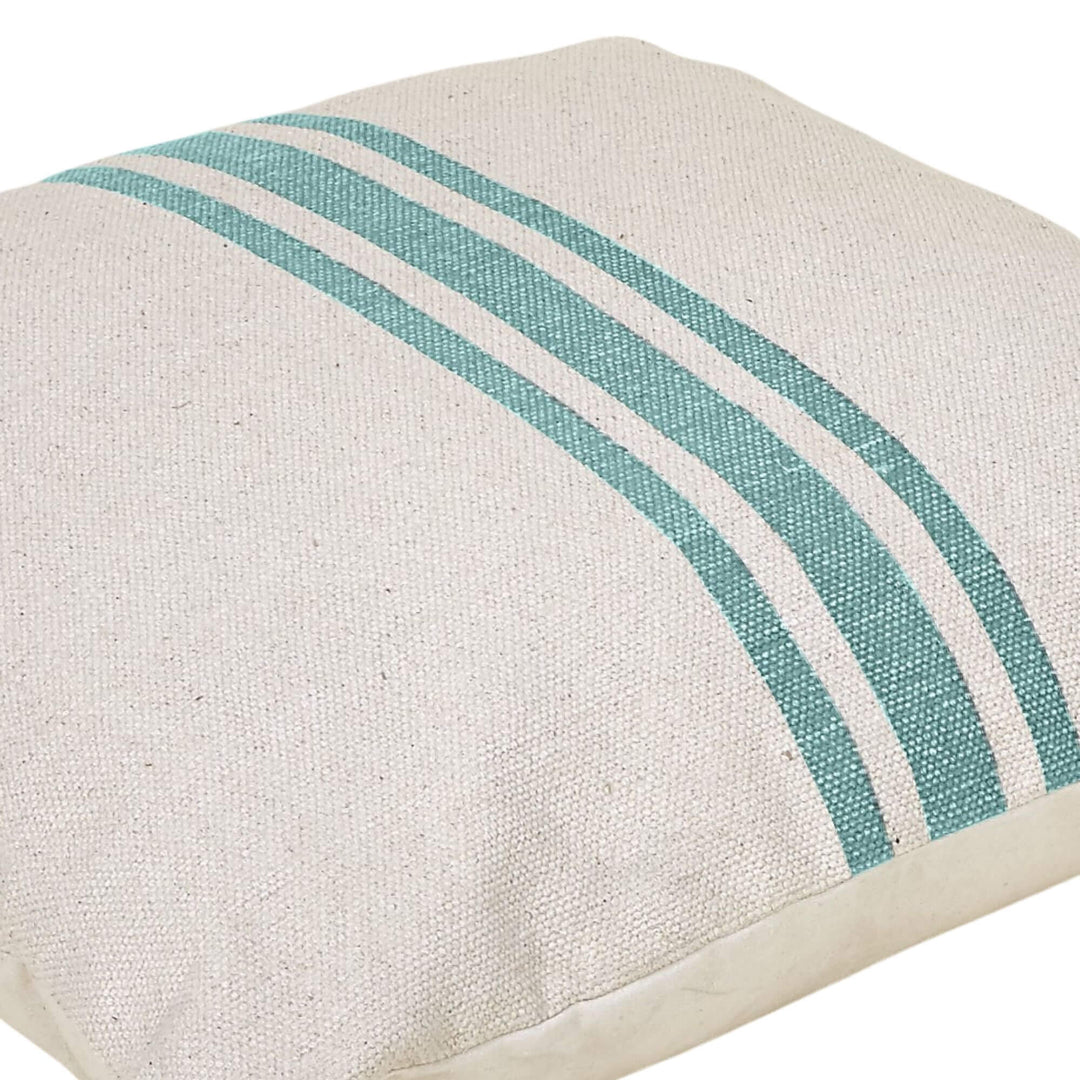Ivory cotton cushion with turquoise stripes, angled view