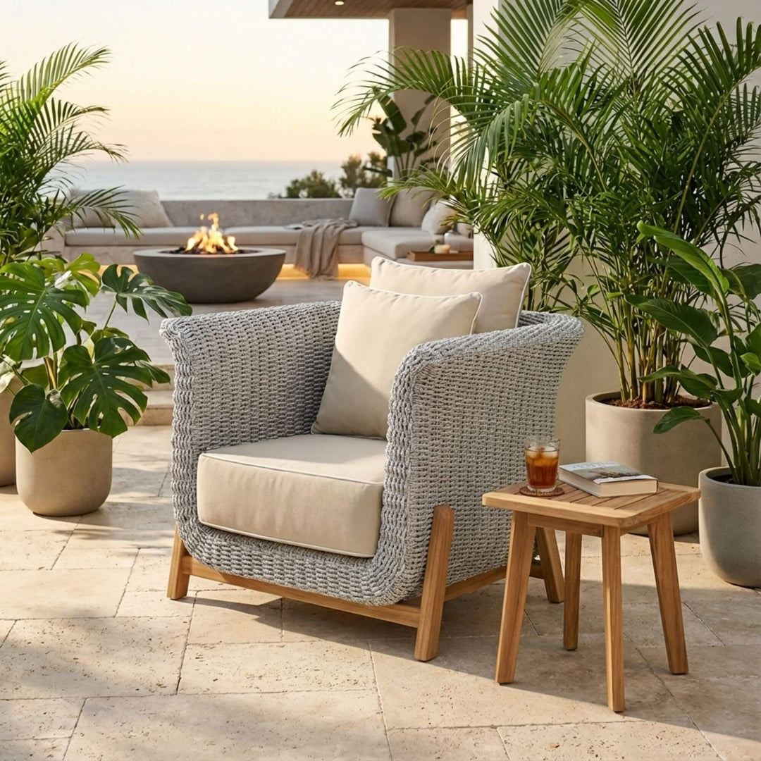 Outdoor lounge setting featuring the Abuk one seater sofa styled with cushions and side table.