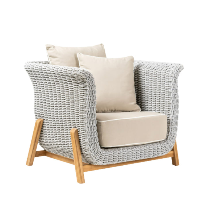 Angled view highlighting the armchair’s deep seat and natural materials.