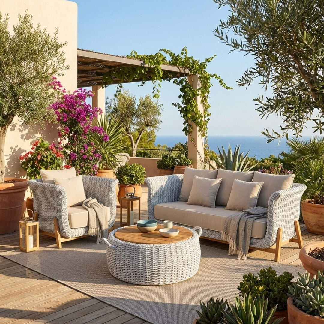 Outdoor lounge setting featuring the Abuk one seater sofa styled with cushions and side table.