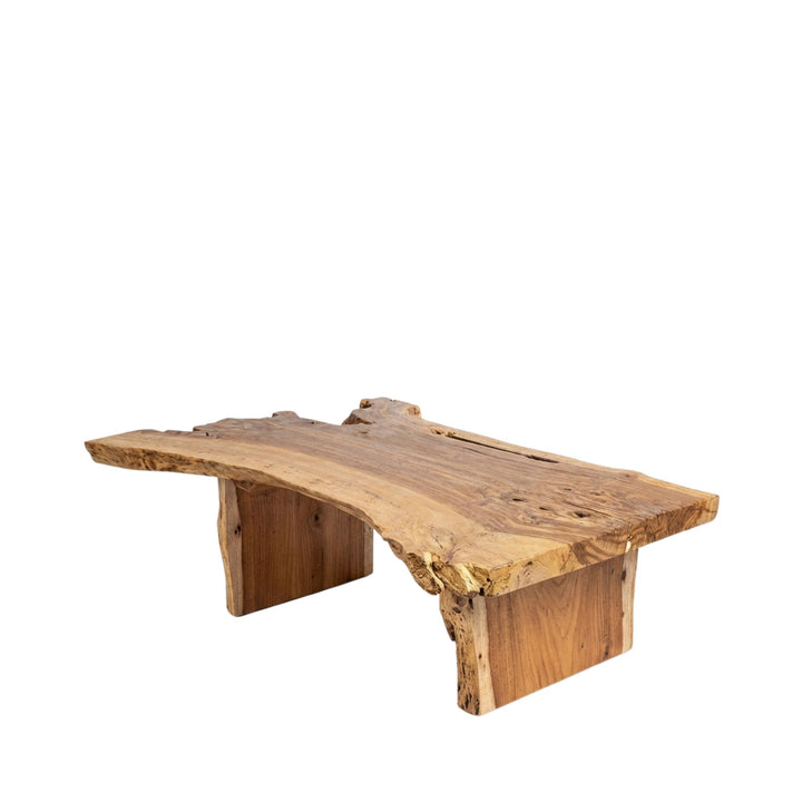 Angled view of the Acacia coffee table showcasing its solid wood top and organic edges.