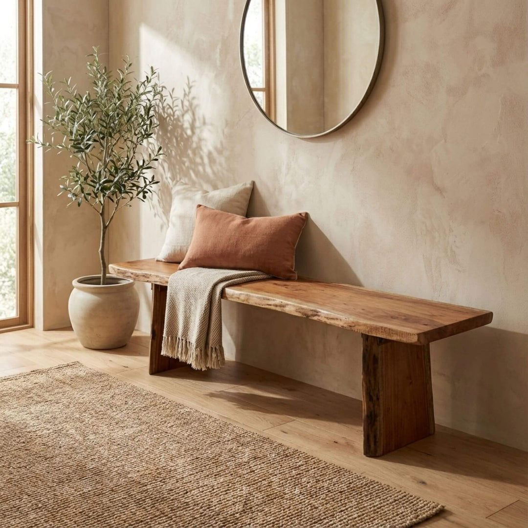 Styled interior setting featuring the Acacia Edge bench placed against a textured wall.