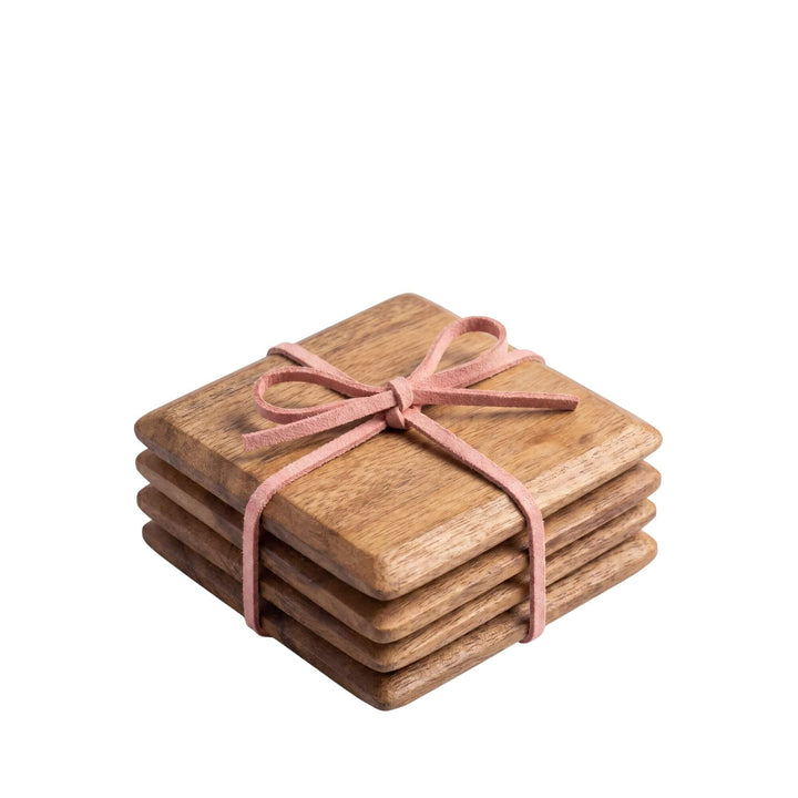 Front view of the acacia coaster set showing four stacked square coasters tied together with a ribbon.