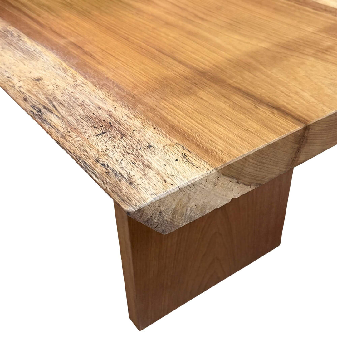 Close-up of the Acacia coffee table highlighting the natural wood grain, organic edge, and solid construction