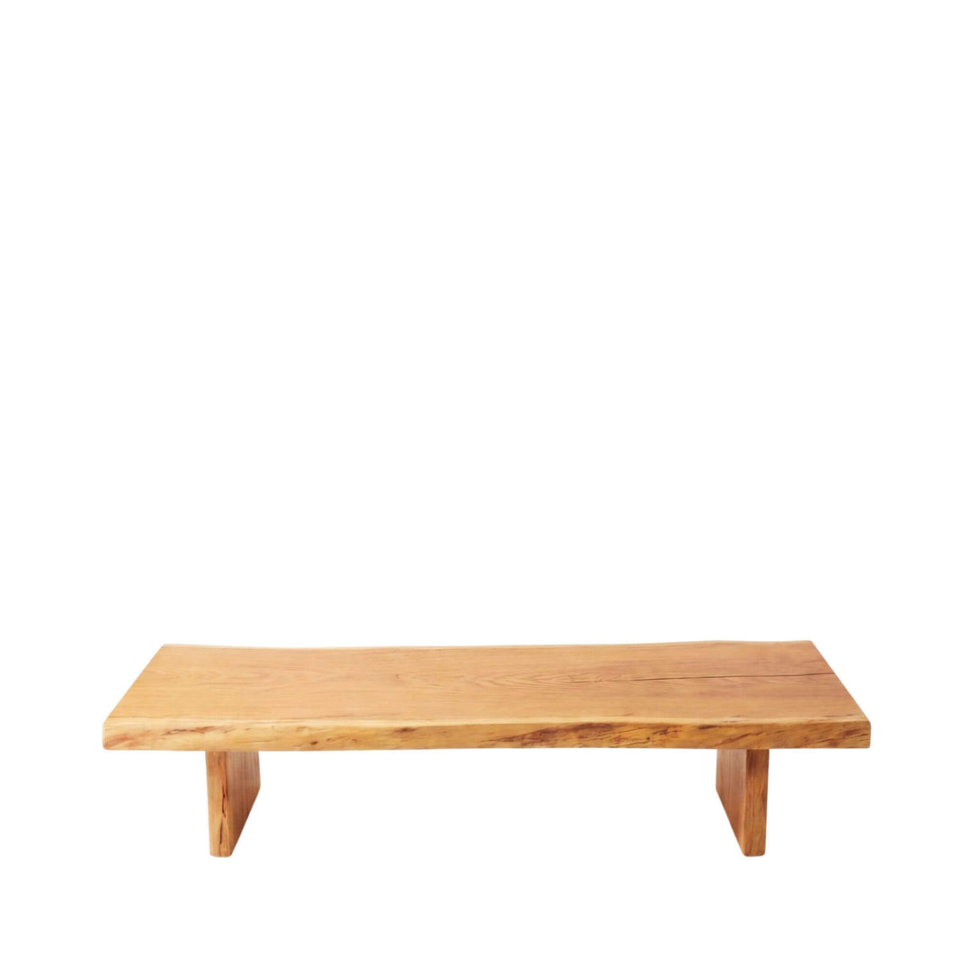Front angled view of the coffee table highlighting its long proportions and natural acacia finish.