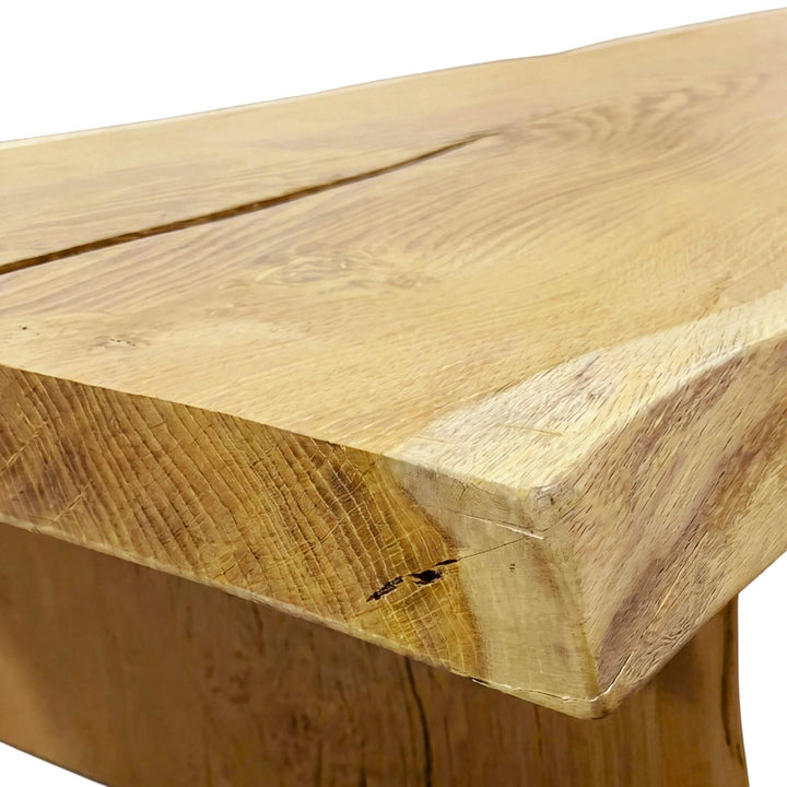 Close-up detail of the tabletop corner showing the rich acacia wood grain and handcrafted edge.