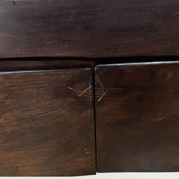 Close-up detail of the cabinet doors showing the rich acacia wood grain, deep brown tones, and natural texture.