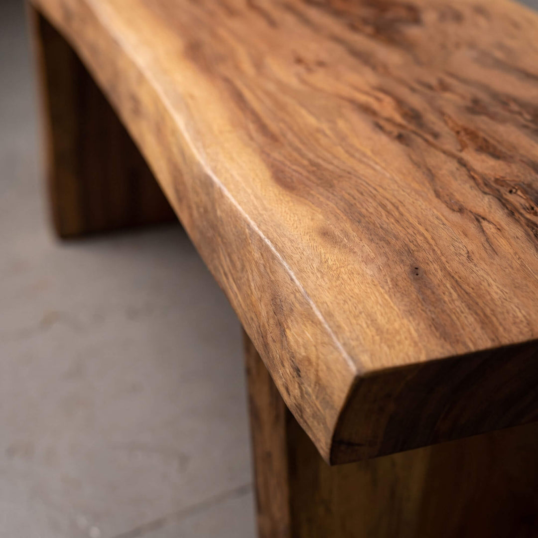 Close-up of the Acacia Wood Bench highlighting the thick solid wood edge and expressive natural grain