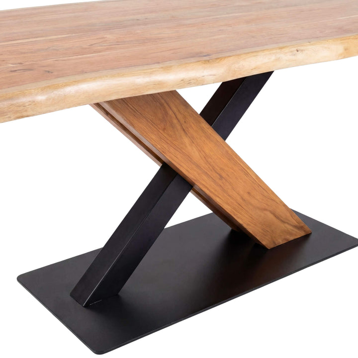 Close-up detail of the X-shaped iron base and live-edge acacia wood top.