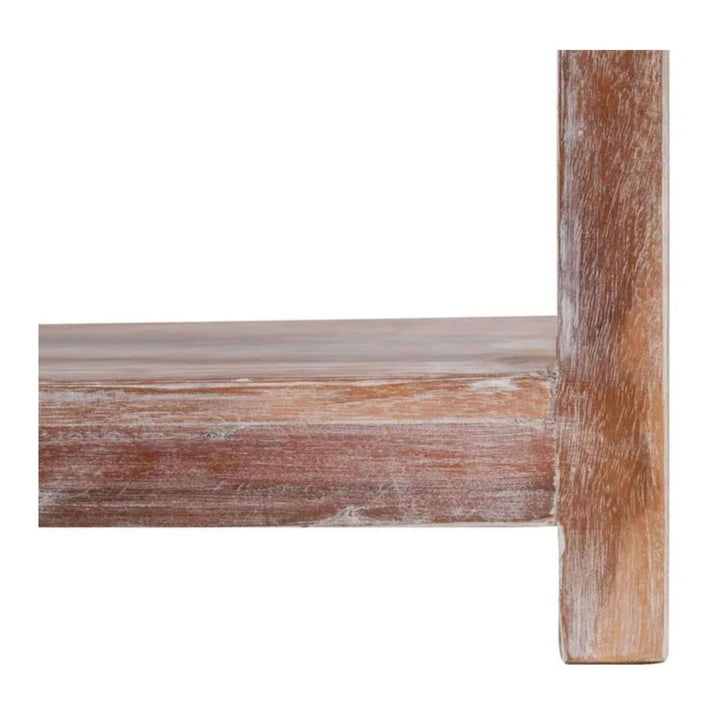 Close-up of the lower shelf and leg of the Adrastea Side Table, showing its whitewashed mango wood texture.