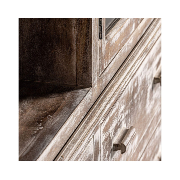Detail of the inner corner of the wardrobe showing the wood grain and white-washed texture.