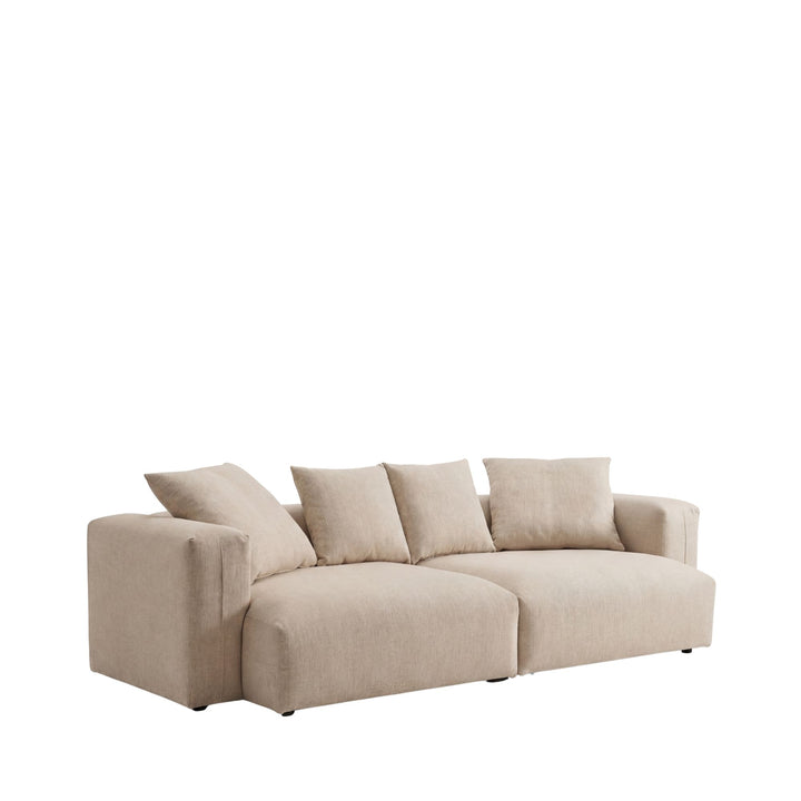 Front view of the Adri sofa showcasing its oversized shape and relaxed cushions in a light neutral fabric.
