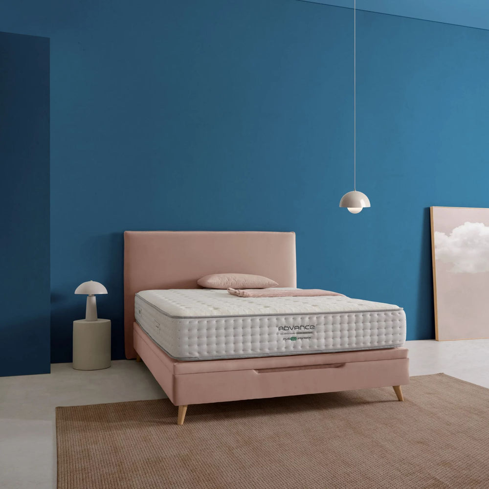 Bedroom setting featuring the Advance Mattress on a contemporary upholstered bed frame.