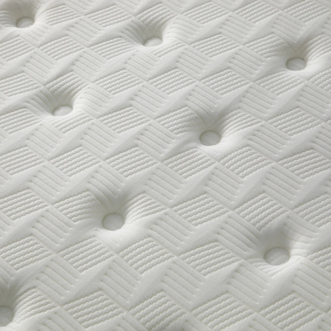 Close-up view of the mattress surface highlighting stitching, breathability, and SuperStretch fabric texture.