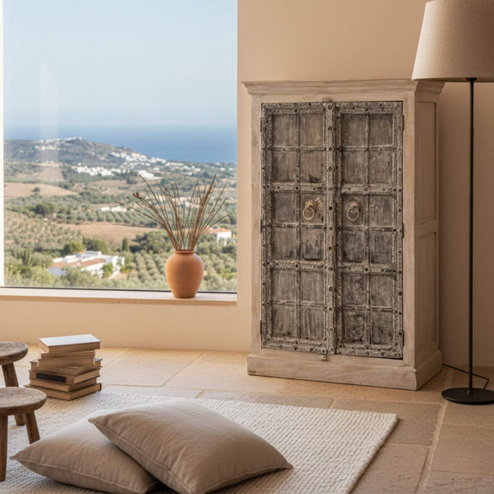 Coastal interior scene featuring the Aeneas wardrobe beside a window.