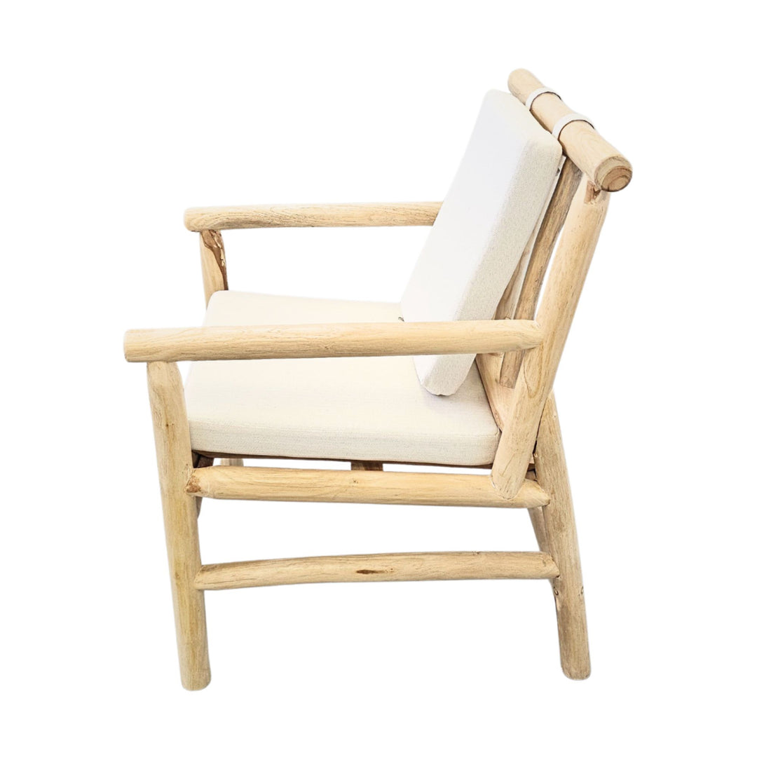 Side view showcasing the teak branch structure and angled backrest cushion of the Akasa dining chair.