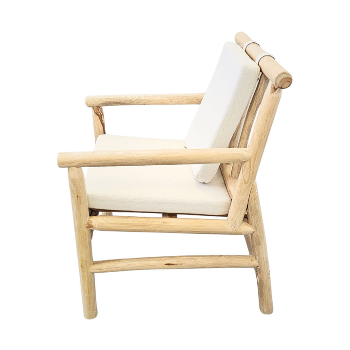 Side view showcasing the teak branch structure and angled backrest cushion of the Akasa dining chair.