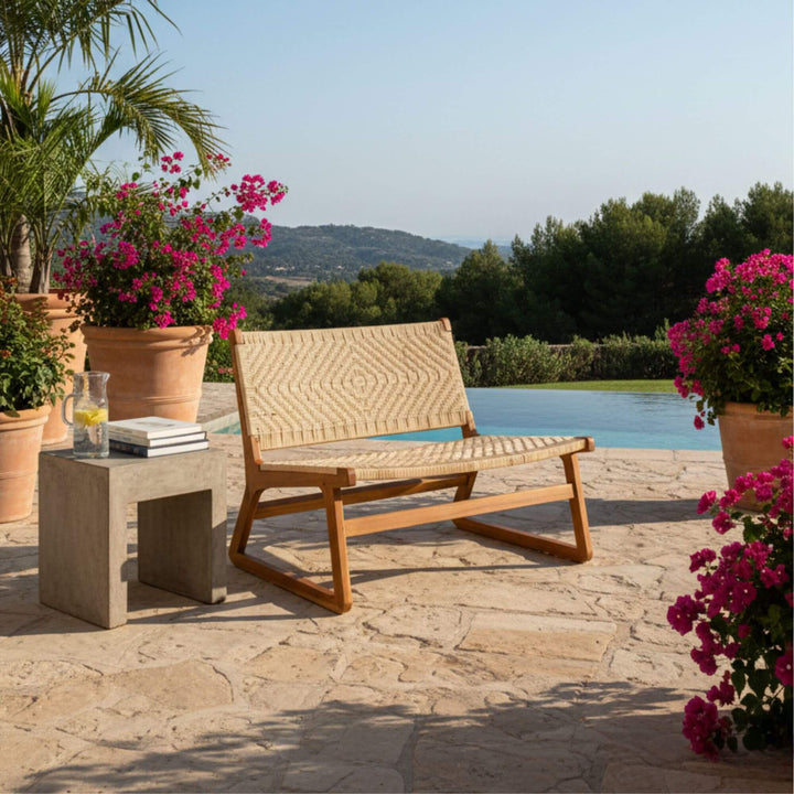 Akrasia teak wood and rattan two-seater sofa styled by poolside