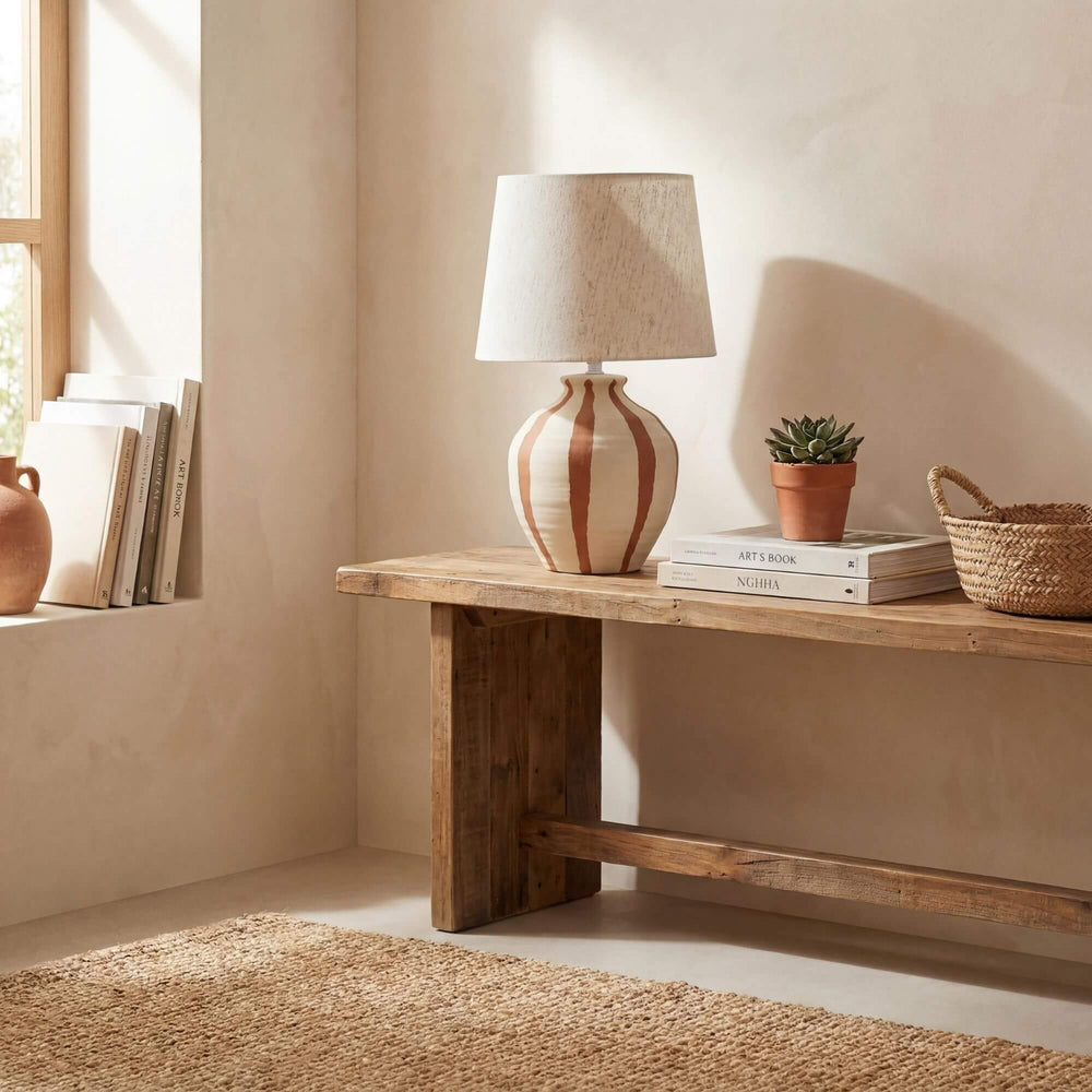 Styled interior setting featuring the Alba table lamp on a wooden console in a warm natural space.