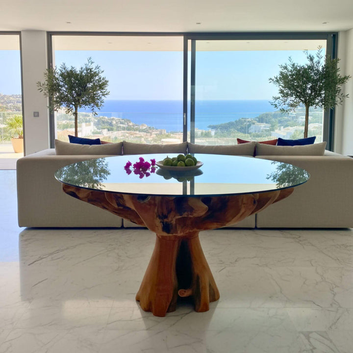 Modern living room with a glass-top dining table and ocean view