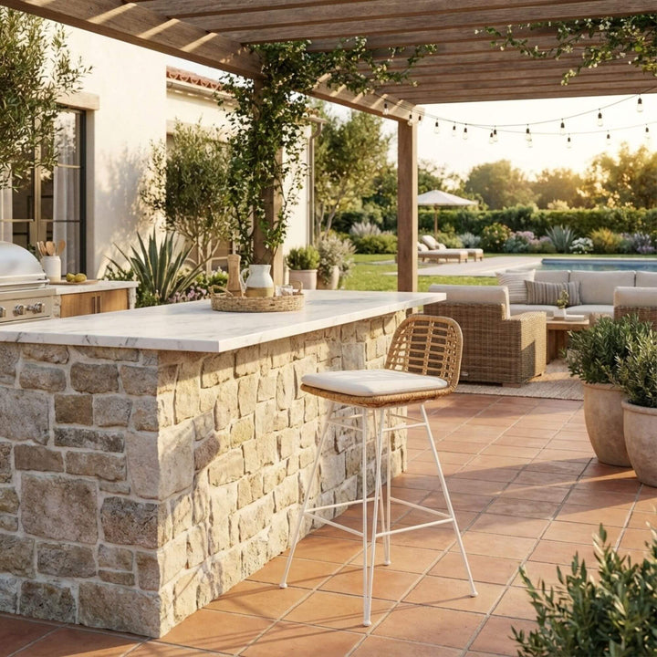 Outdoor patio with stone bar, Amalfi Bar Stool, and garden setting