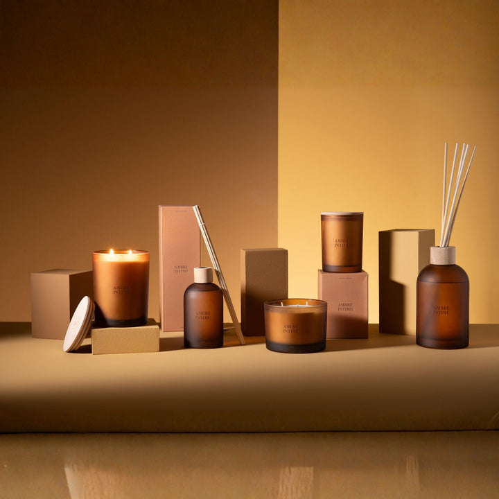 Group display featuring Amber Intime Diffuser with matching scented candles and accessories.