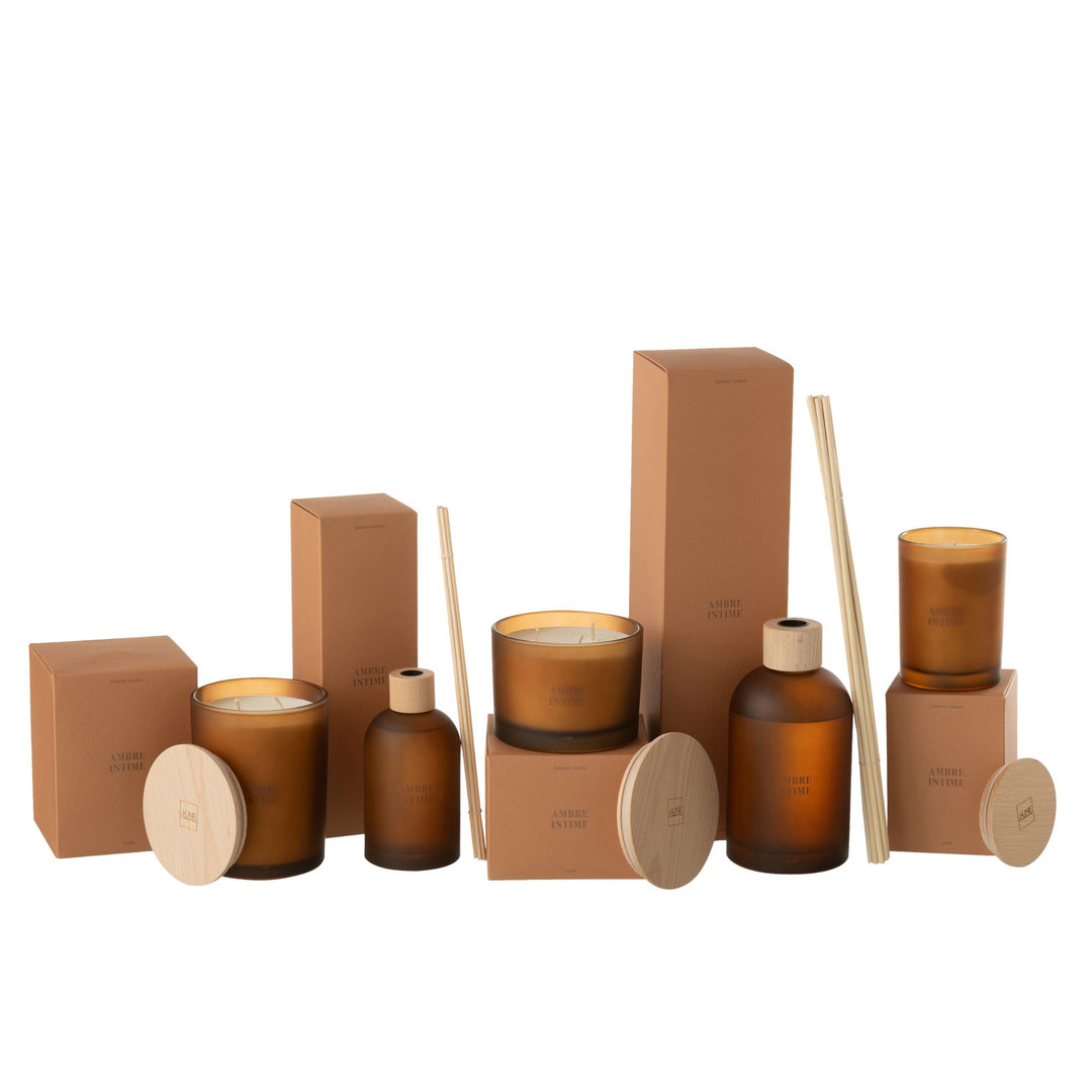 Amber Intime candle collection featuring multiple sizes arranged decoratively.