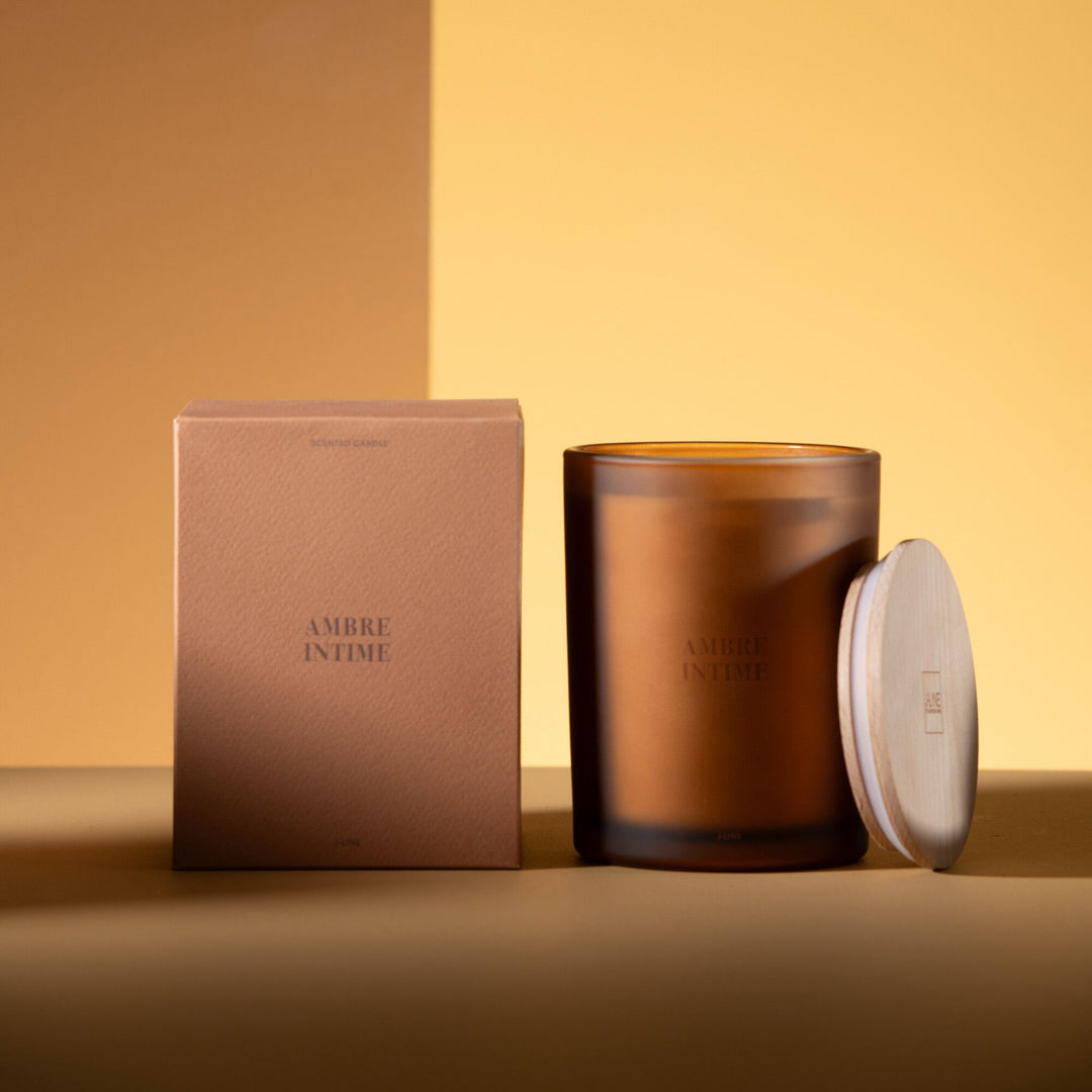 Large Amber Intime candle showcased with box and wooden lid detail.