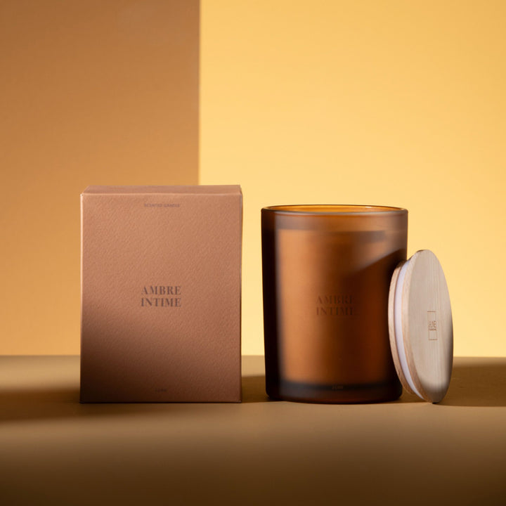 Large Amber Intime candle showcased with box and wooden lid detail.
