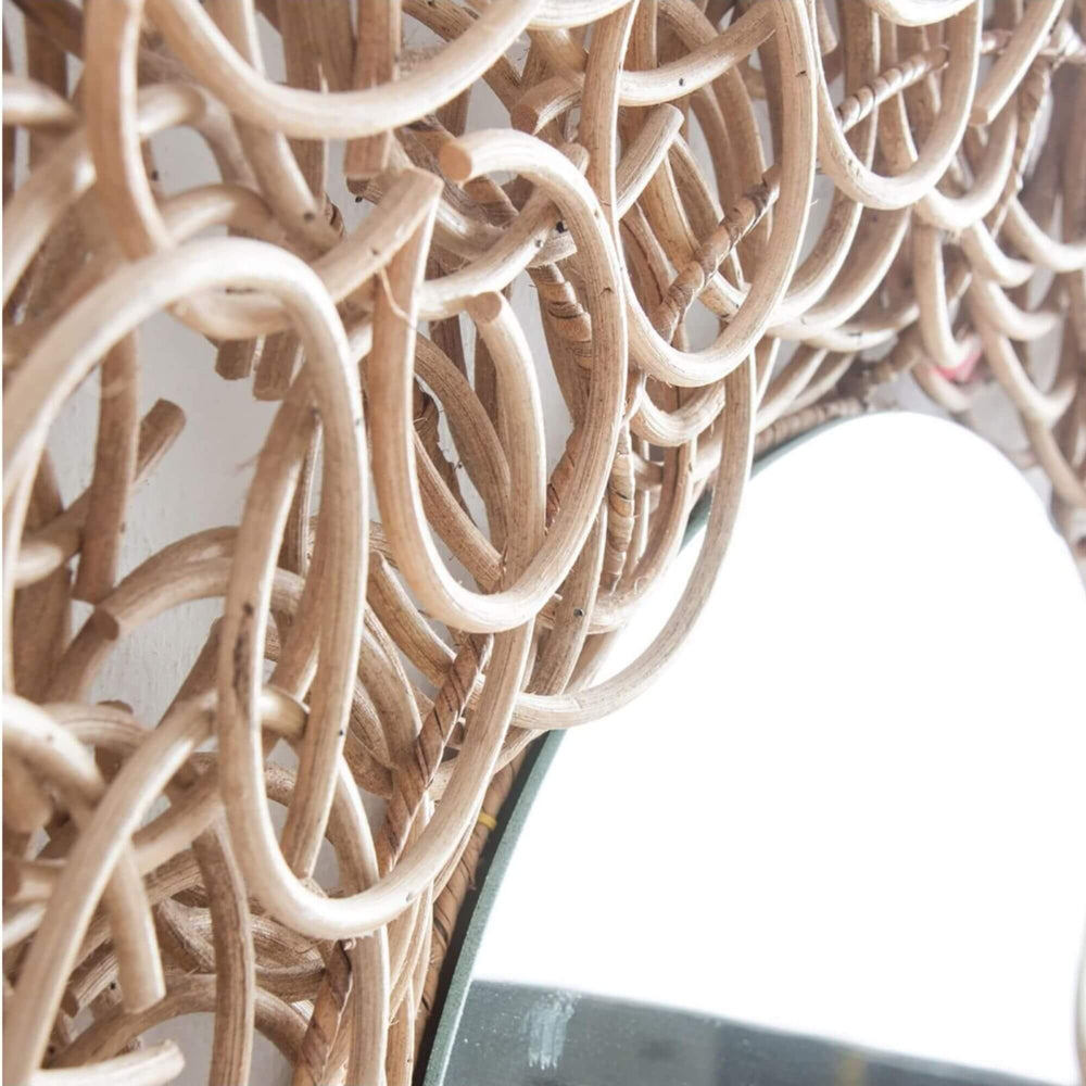 Close-up detail of the Amur Mirror’s woven rattan loop design.