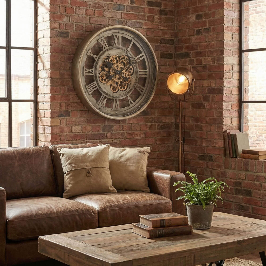 Styled industrial living room featuring the Ananke Roman clock mounted on a brick wall above a sofa.