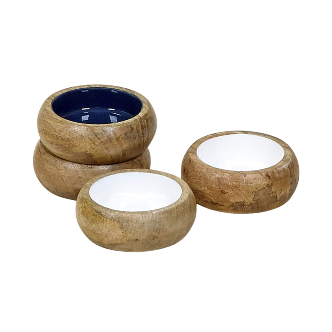 Set of small mango wood bowls with white and navy interiors stacked and displayed together.