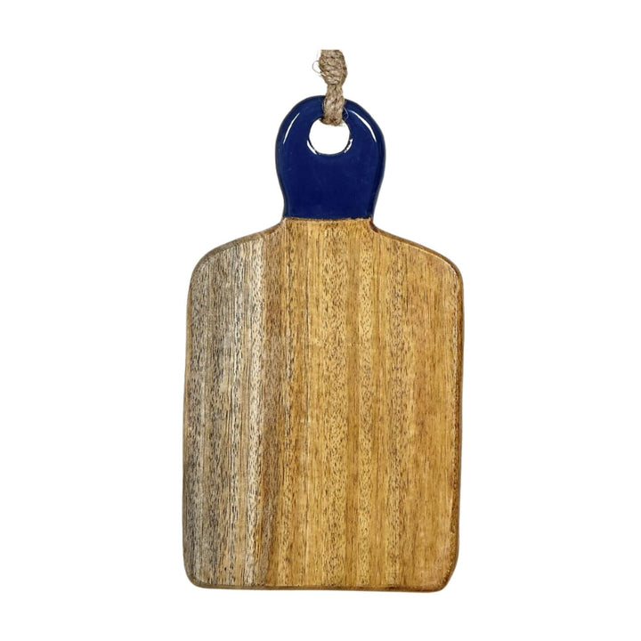 Mango wood chopping board with a navy ceramic handle hanging from a jute rope.