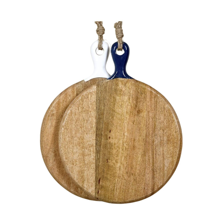 Set of two Anaya round mango wood chopping boards with white and navy ceramic handles displayed together.