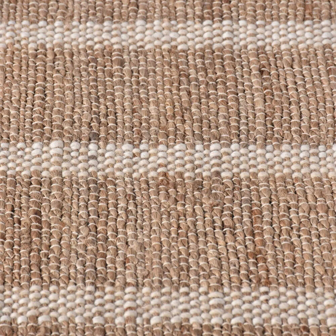 Close-up of the Anihar Rug highlighting the handwoven jute and wool fibers.