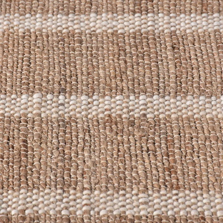 Close-up of the Anihar Rug highlighting the handwoven jute and wool fibers.
