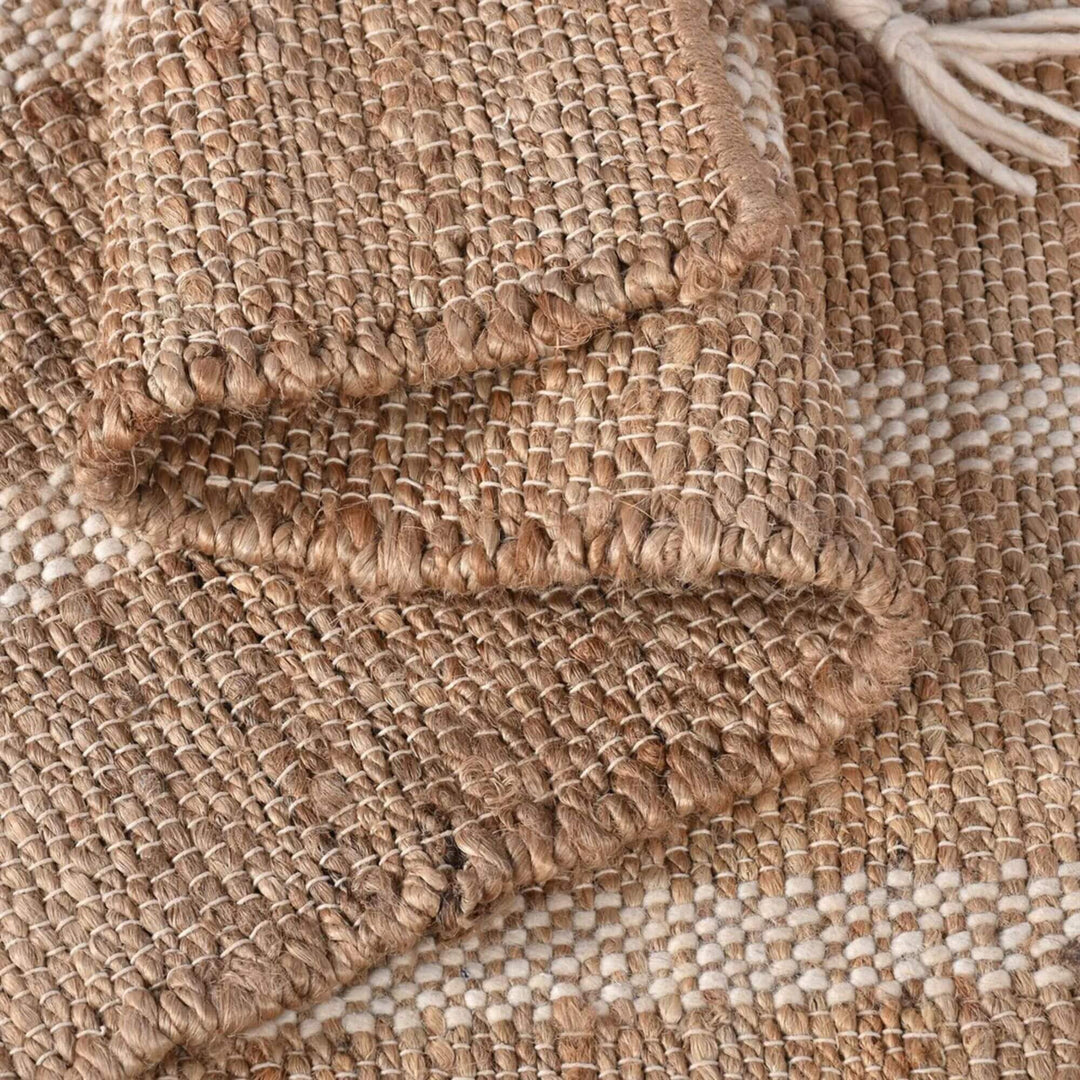 Detailed view of the rug edge showing tassel finish and natural weave texture.