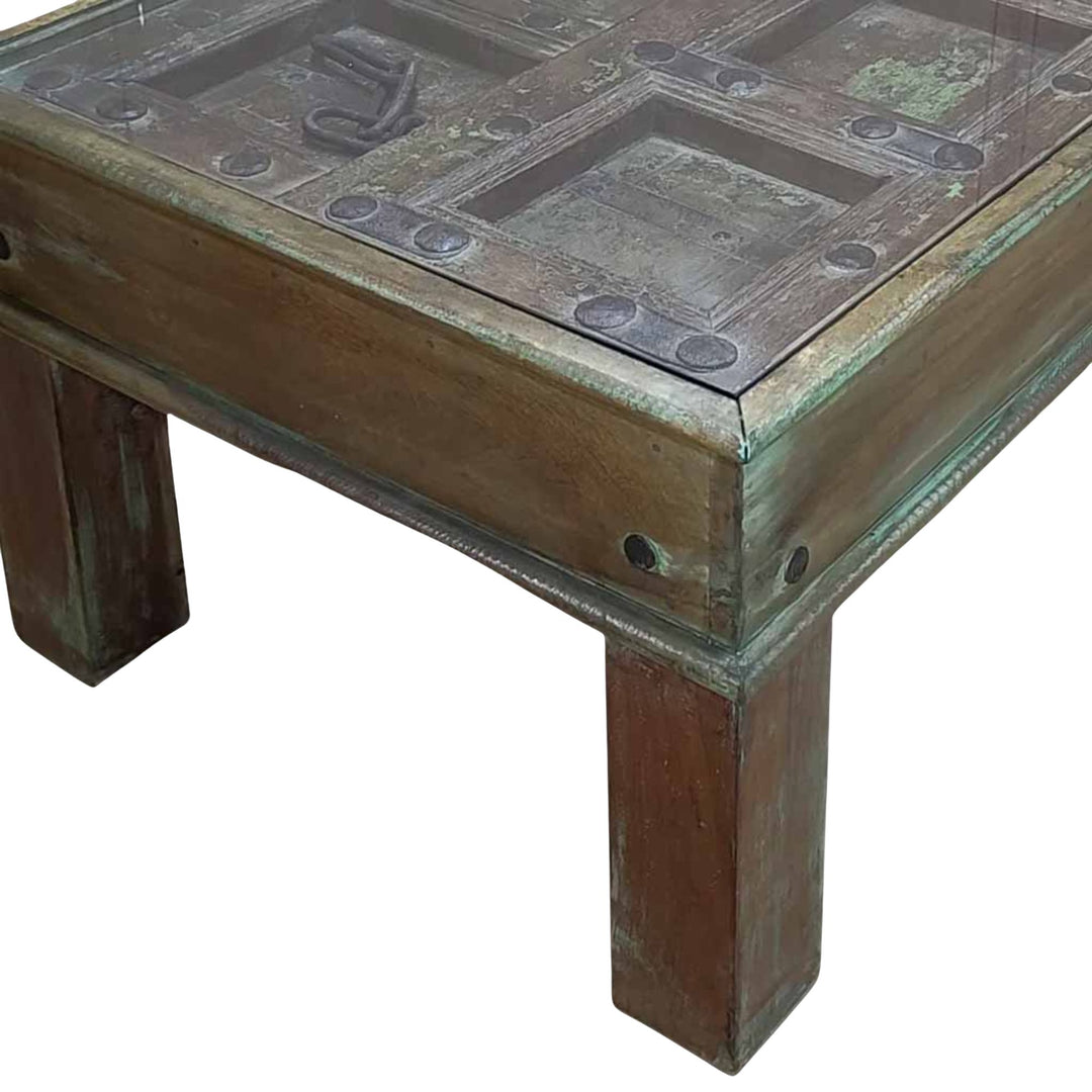 Close-up detail of the carved door panel showing original textures and historic markings.