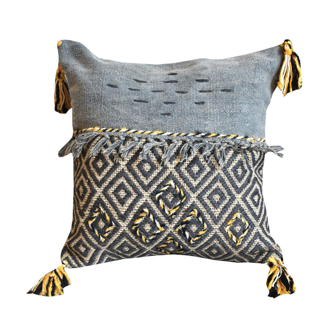 Arambol Cushion with geometric embroidery, fringe, and tassels in grey, yellow, and black.