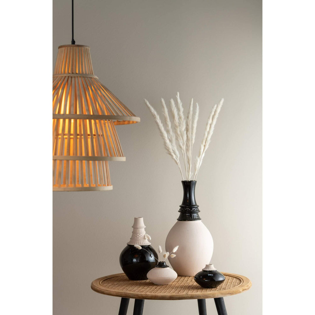 Interior styling scene featuring the Aran Vase White with decorative dried stems.