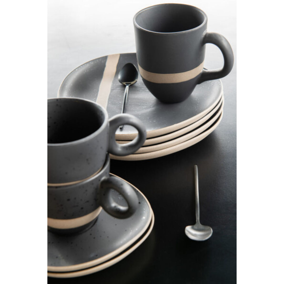 Arcai tableware collection styled on a black dining table with cup and mug