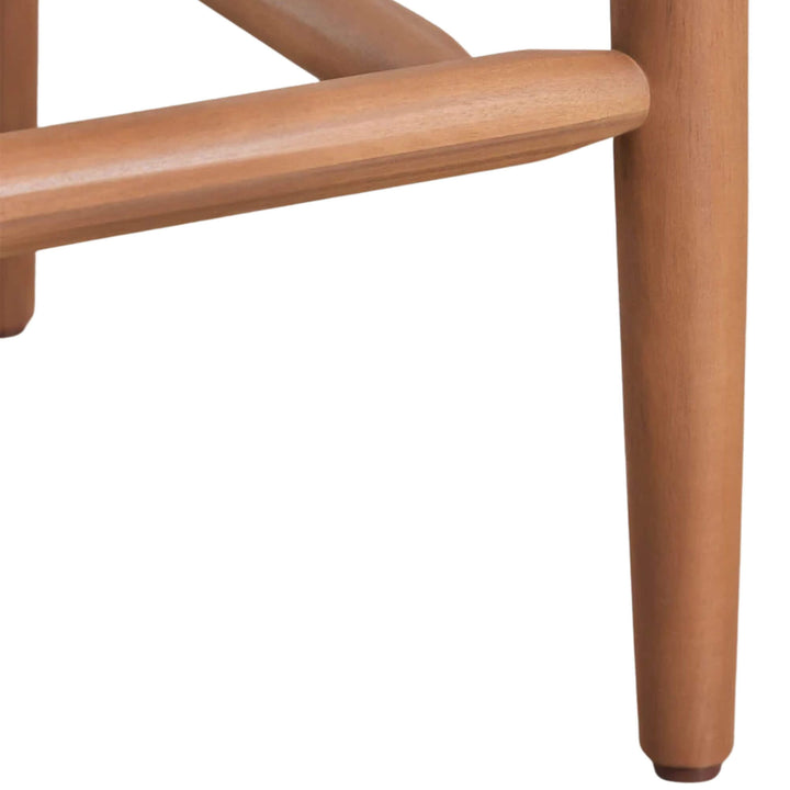 Close-up detail of the wooden footrest and tapered acacia leg.