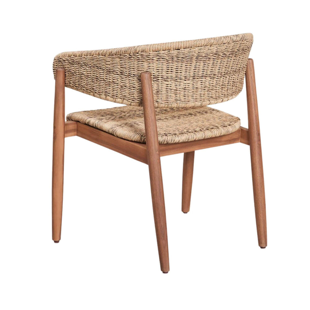 Rear three-quarter view of the chair showing the curved woven backrest and tapered legs.