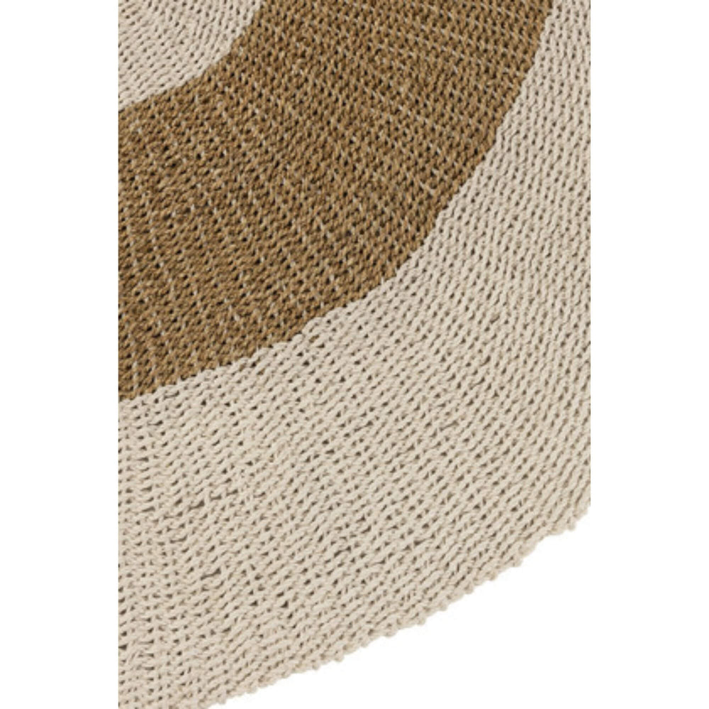 Close-up of circular Arena Rug made of natural woven fibers in neutral tones.

