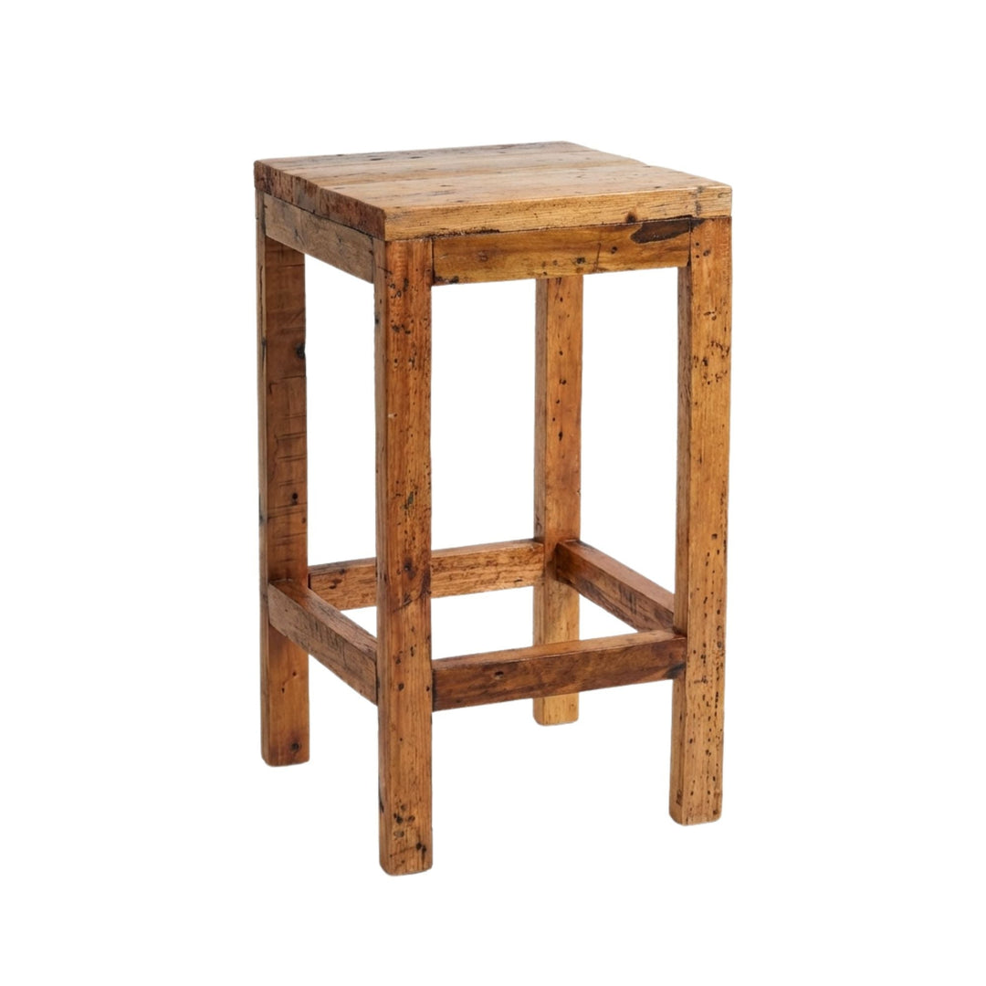 Angled view of Armazi Bar Stool made from reclaimed teak wood with a square, rustic design.