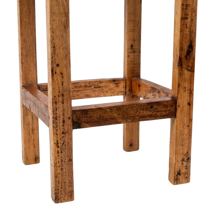 Detail view of Armazi Bar Stool legs highlighting reclaimed teak wood grain and natural imperfections.
