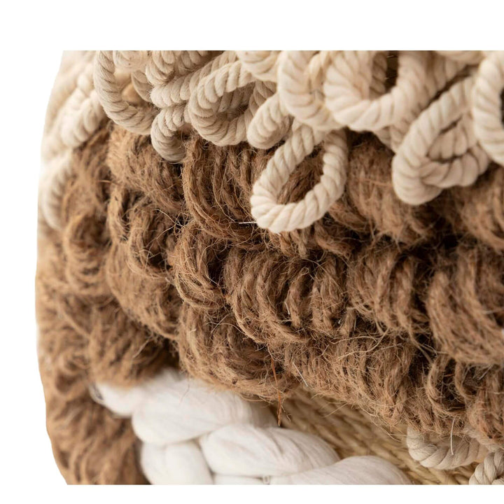 Close-up of seaweed and cotton decorative basket for home storage.